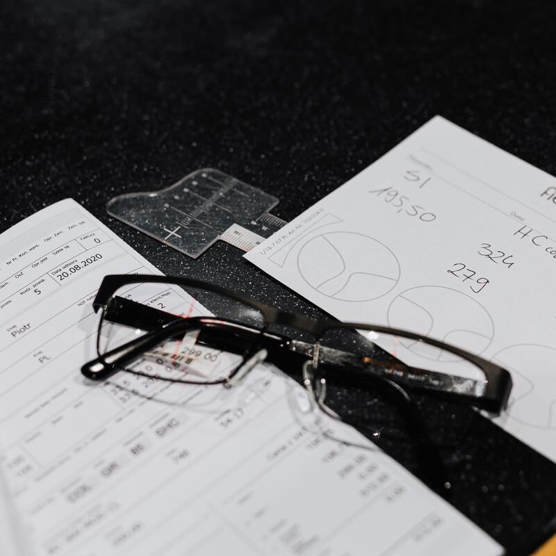 image of a pair of glasses placed on top of technical documents.